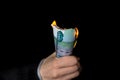 Pack of burning rubles in personÃ¢â¬â¢s hand horizontal